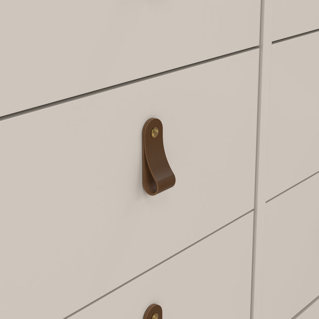 Brown leather drawer handle with a brass screw on a white dresser drawer front