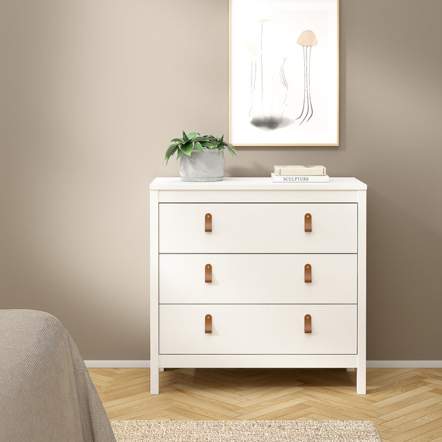 Three-drawer chest in white with leather pull handles and a smooth finish, placed against a neutral wall