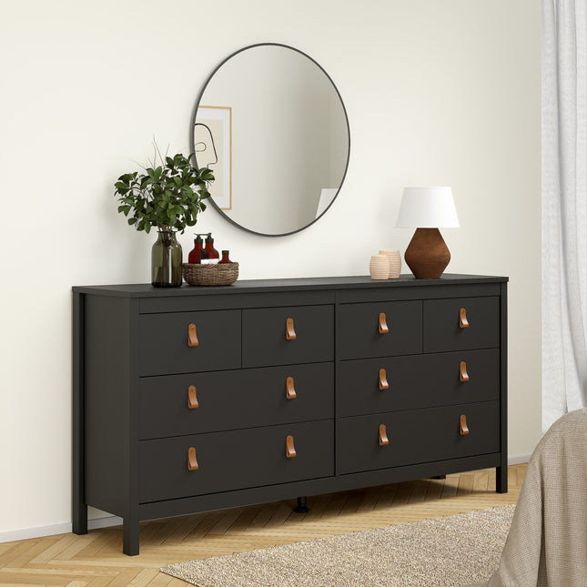 Double dresser with eight drawers featuring leather strap handles, finished in black, set against a light wall