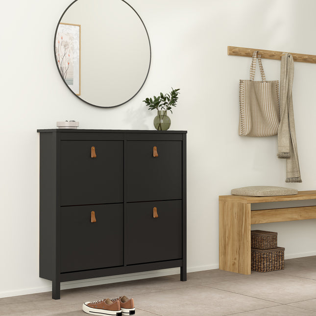 Cabinet with four compartments, black finish, featuring leather handles, set against a light wall with a round mirror