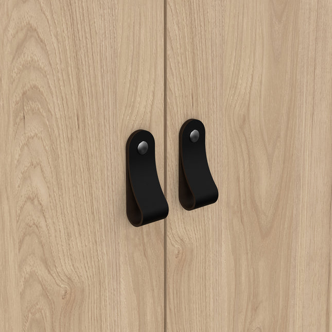 Close-up of two wooden cabinet doors with a light wood finish and black metal handles