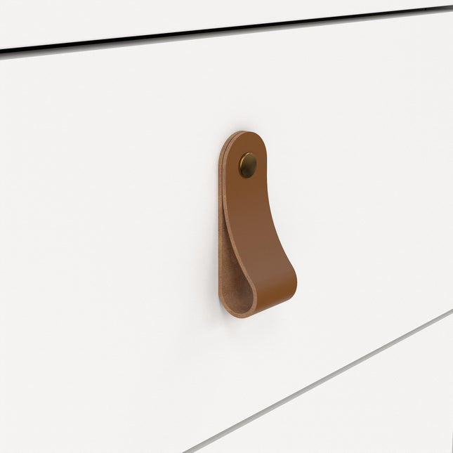 Leather handle in tan with a brass stud, attached to a white drawer front