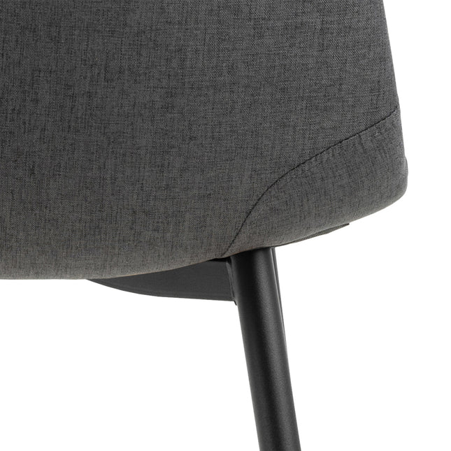 Curved backrest chair with a textured grey fabric seat and slender black metal legs