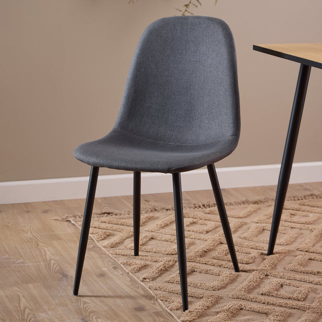 Dining chair with a curved backrest and tapered black legs, upholstered in light grey fabric