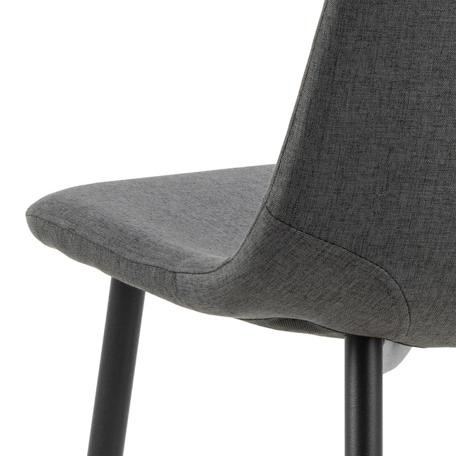 Dining chair with a curved backrest and padded seat in light grey fabric, supported by black metal legs