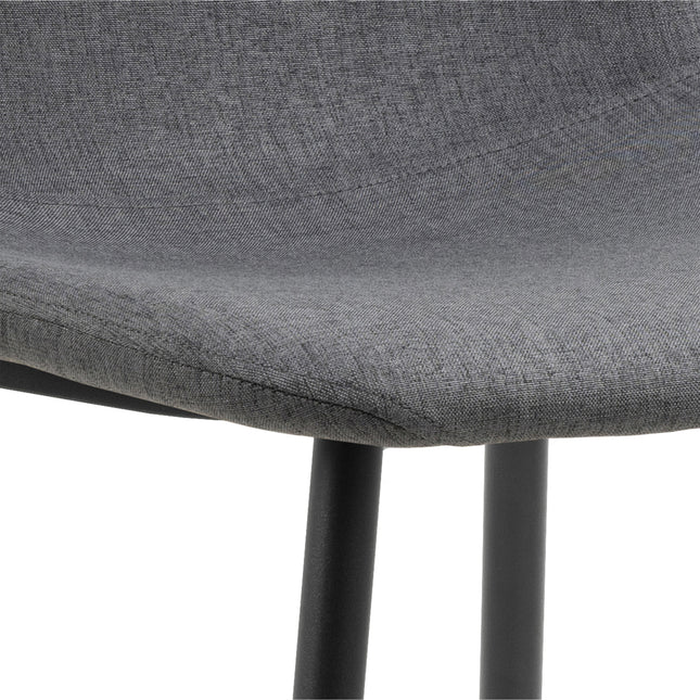 Curved chair seat in light grey fabric with a smooth finish and black metal legs