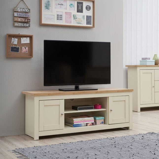 TV unit with a light wood top, cream body, two cupboards, and an open shelf for storage beneath a flat-screen television