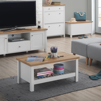 Rectangular coffee table with a light wood top and white base, featuring a lower shelf for storage, placed on a textured rug
