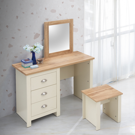 Dressing table with three drawers, light wood top, cream base, and a matching stool, accompanied by a small vase of flowers