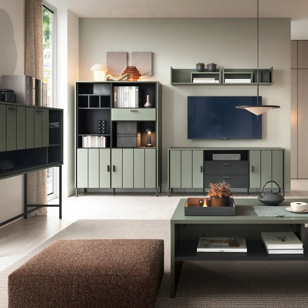 TV cabinet with two doors and two drawers, finished in dark green, paired with a matching shelving unit and coffee table