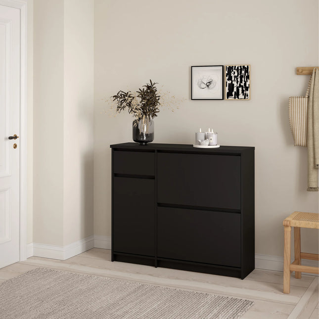 Naia shoe cabinet in matte black with two drop-front compartments and decorative vase on top