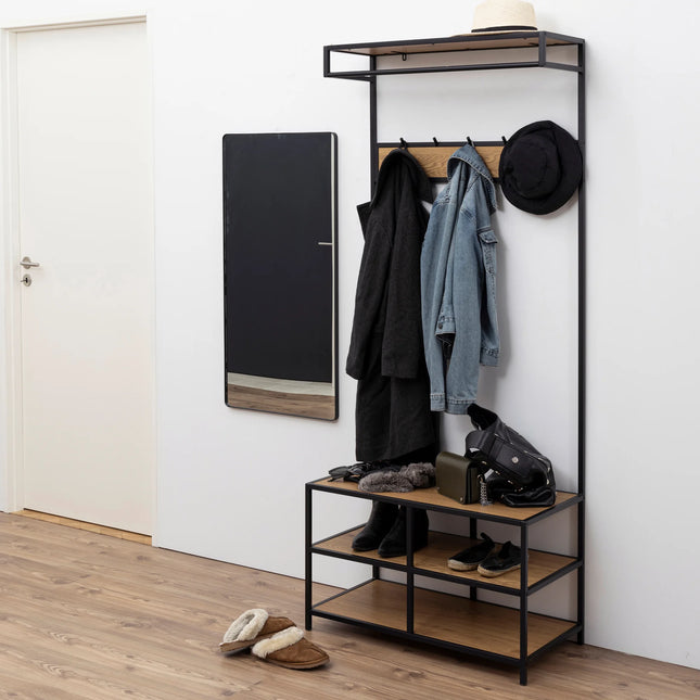 Seaford black metal clothes rack with oak-effect shelves and coat hooks, styled with jackets and shoes