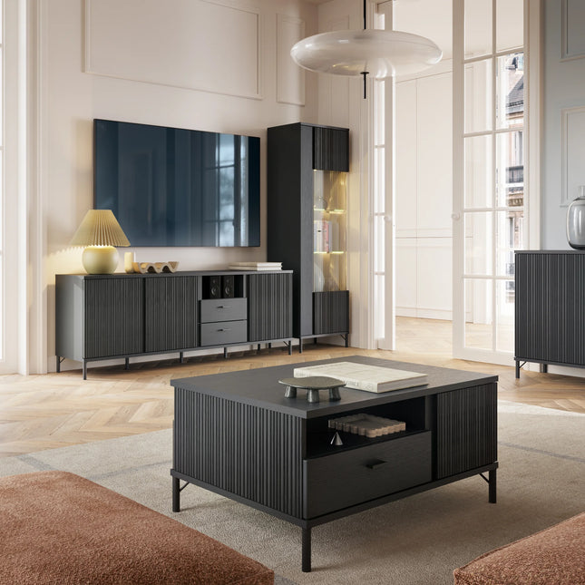Avenale coffee table close-up showing black fluted paneling, open shelf and slim metal legs