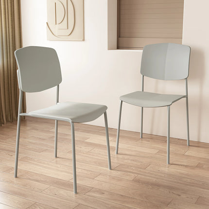 Pair of pale grey Aspen dining chair backs and metal legs on wood floor
