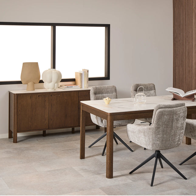 Sideboard top with two decorative ceramic lamps and stacked books on dark wood finish