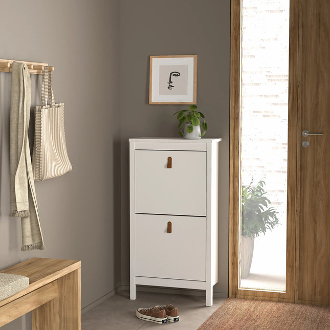 Barcelona shoe cabinet detail showing white two-flap front with leather pull handles and slim legs
