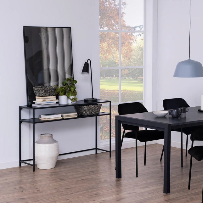 Seaford console table slim black metal frame with narrow shelving and decorative vase