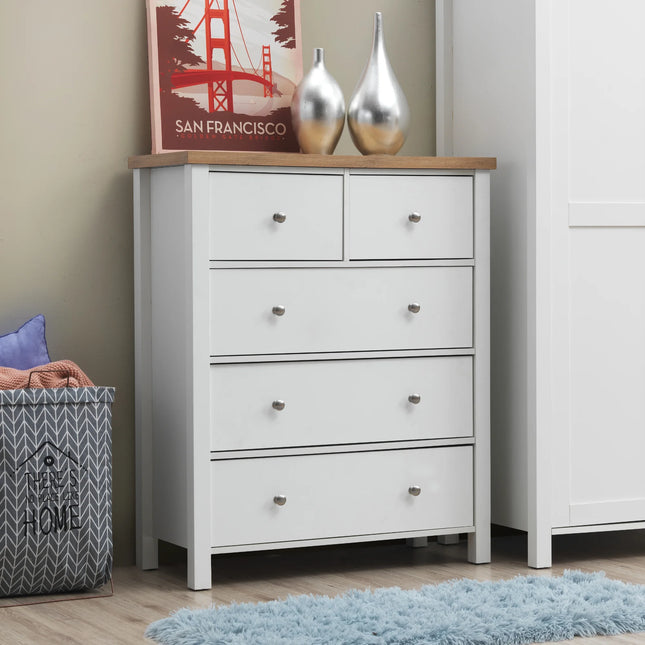 Close-up of Astbury white 5-drawer chest with oak-effect top and round metal knobs