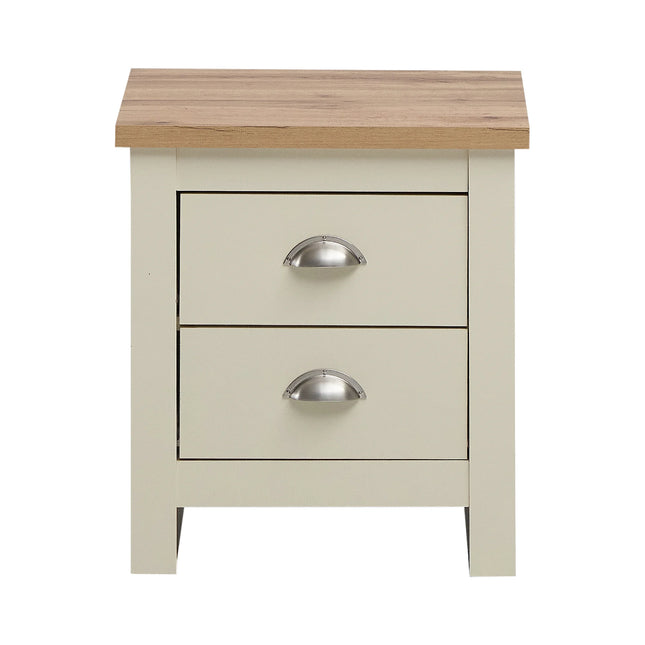 Close-up of oak-effect top and two cream drawer fronts with silver cup handles