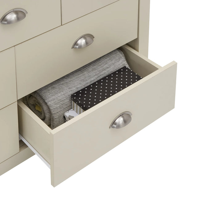 Lisbon chest drawer open with silver cup handle and folded knit blanket inside