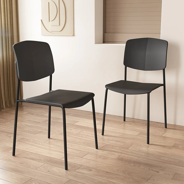 Aspen dining chair pair in matte black with slim metal legs and curved seatbacks