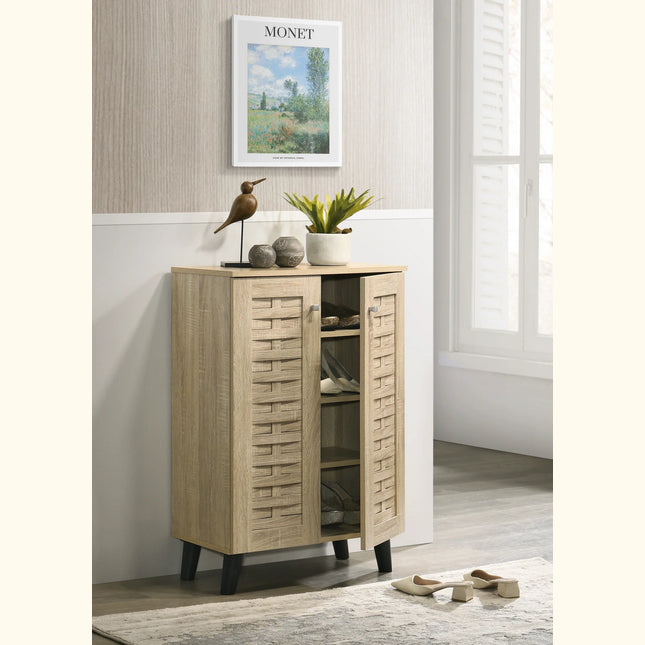 Close-up of woven-pattern oak-effect shoe cabinet door, black tapered legs and open centre shelf