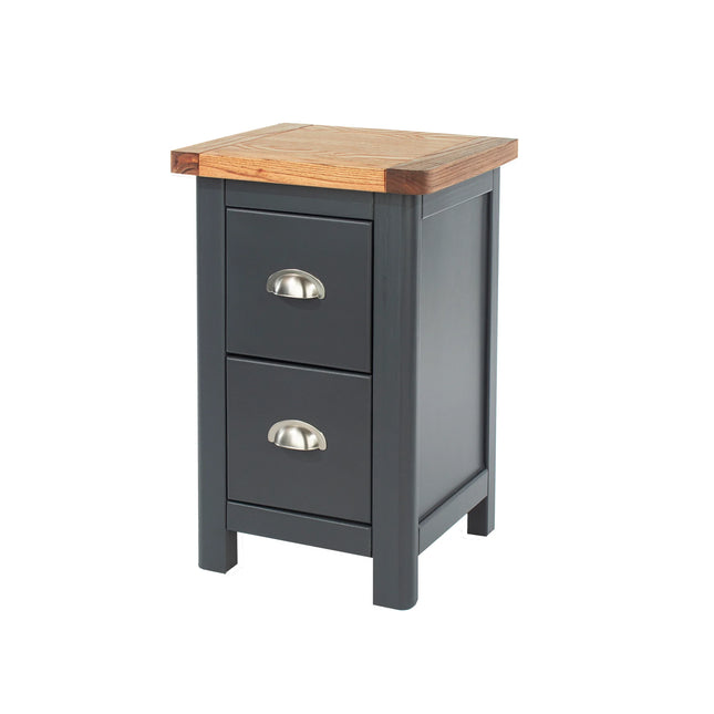 Close-up of bedside cabinet top edge with oak top and charcoal painted drawer front and metal cup handle
