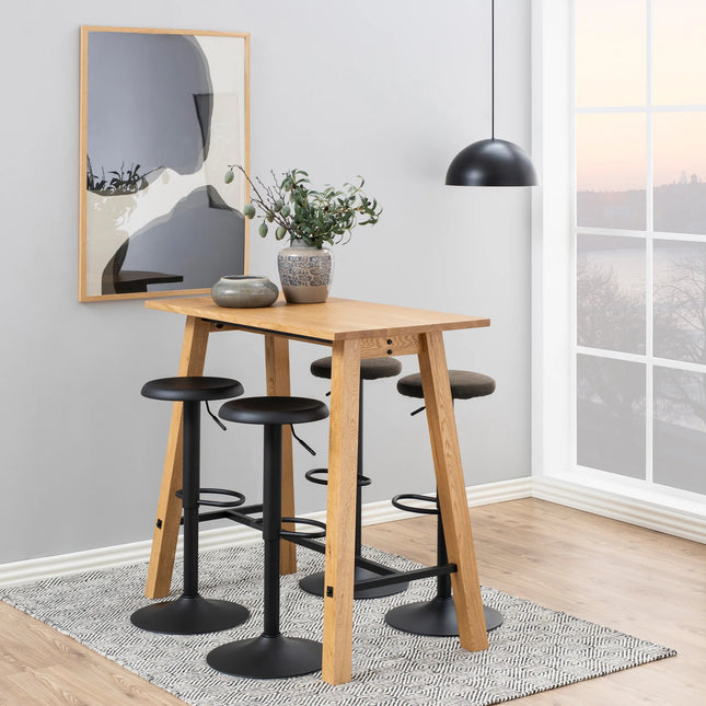 Close-up of Finch bar stool round black swivel seat with matte black pedestal and footrest