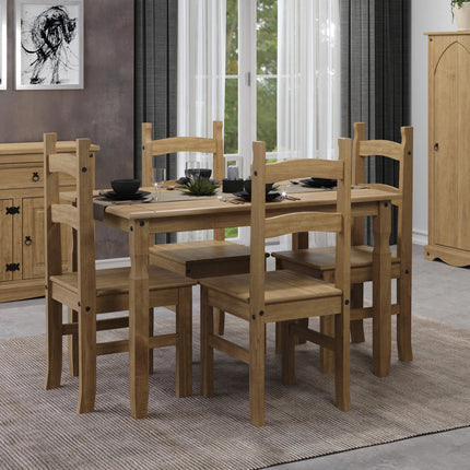 Close-up of four solid pine dining chairs with curved back rails and visible black fixing bolts