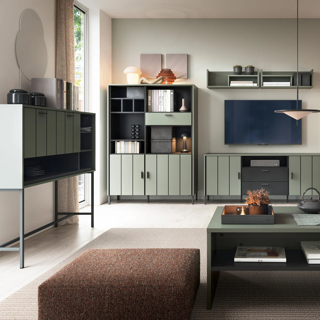 living room arrangement with olive-green storage cabinets, wall shelves and TV, low coffee table corner visible